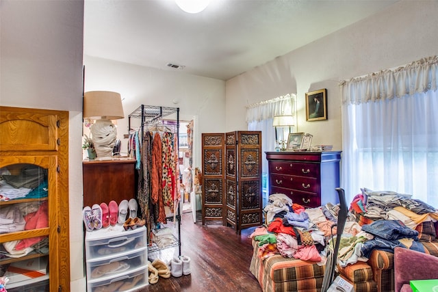 bedroom featuring visible vents and wood finished floors