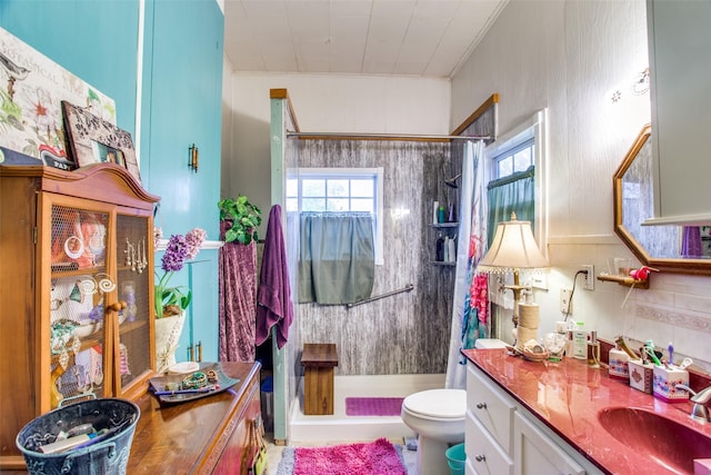 bathroom featuring toilet, a shower stall, ornamental molding, and vanity