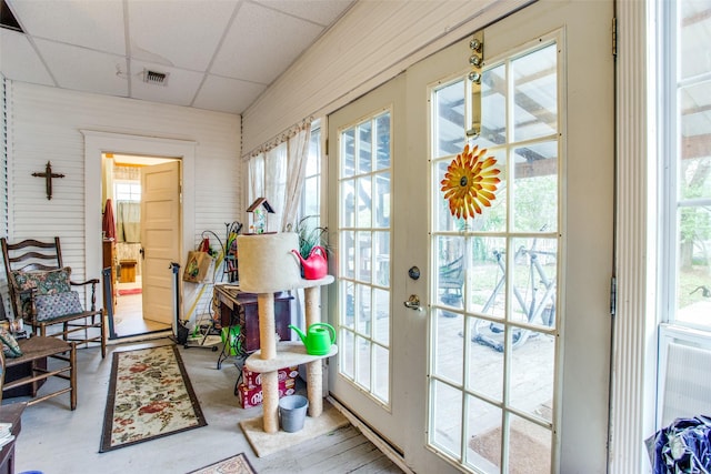 sunroom / solarium with a drop ceiling and visible vents