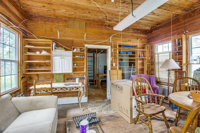 sitting room with hardwood / wood-style floors, wooden ceiling, and beam ceiling