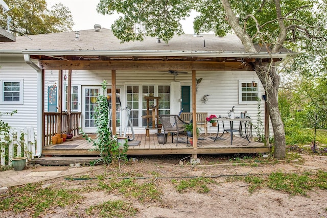 rear view of property featuring a ceiling fan and a deck