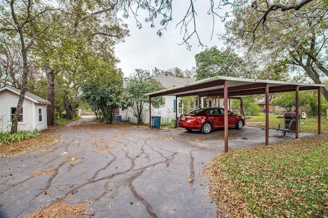 view of parking / parking lot featuring a detached carport and driveway