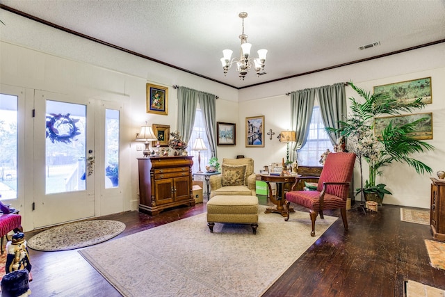 sitting room featuring a wealth of natural light, visible vents, and dark wood-type flooring