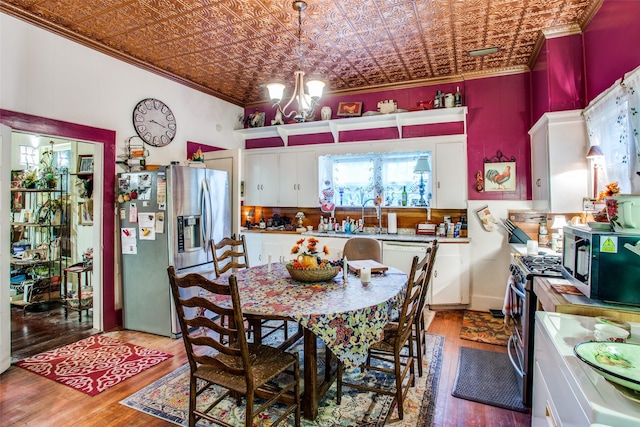 dining space with an inviting chandelier, an ornate ceiling, and crown molding