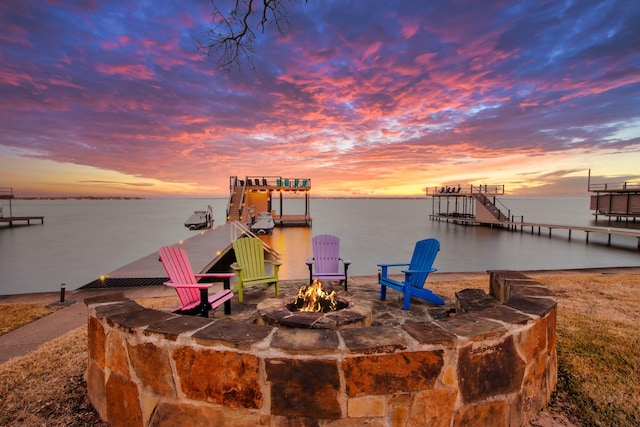 dock area featuring an outdoor fire pit and a water view