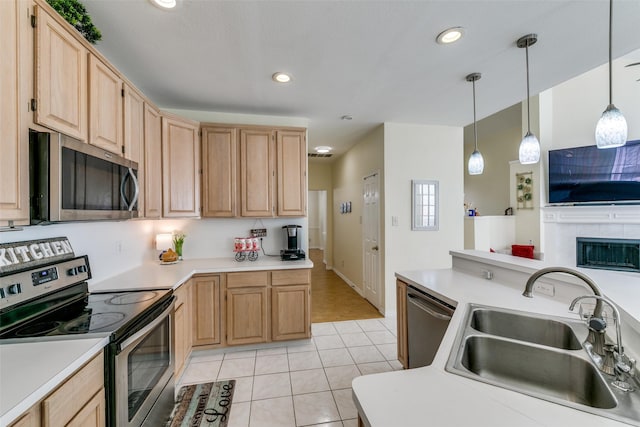 kitchen with a sink, stainless steel appliances, and light brown cabinets