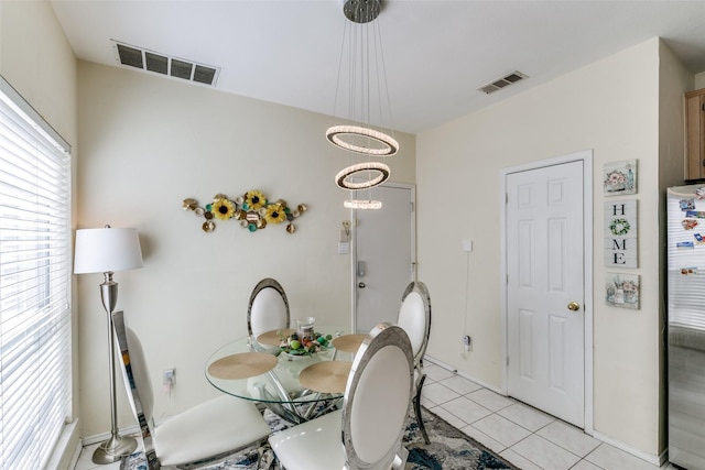 dining room featuring light tile patterned floors and visible vents