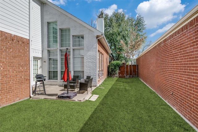 view of yard featuring a patio and fence