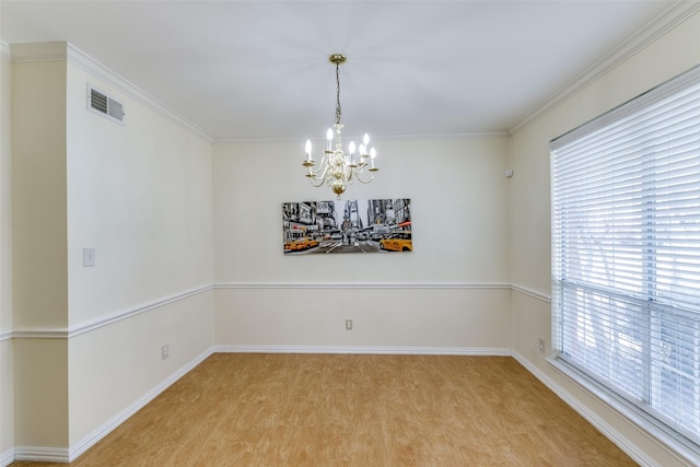 unfurnished room with crown molding, visible vents, a chandelier, light wood-type flooring, and baseboards