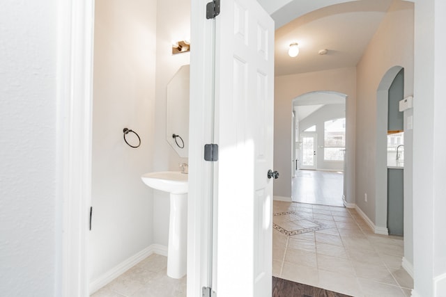 bathroom featuring vaulted ceiling and baseboards