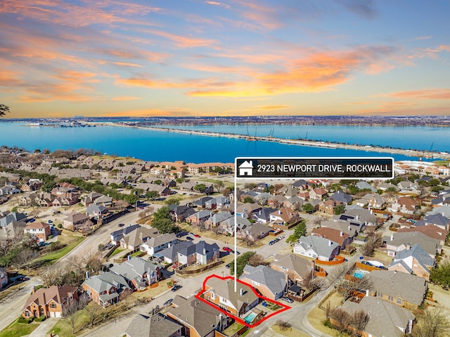 bird's eye view featuring a water view and a residential view