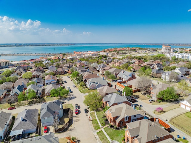 drone / aerial view with a residential view and a water view