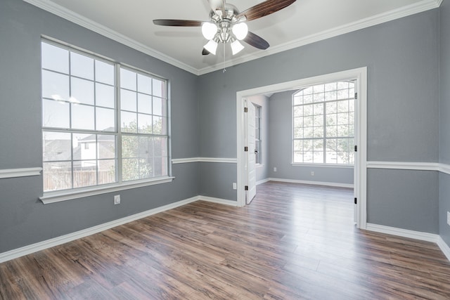 unfurnished room featuring a ceiling fan, crown molding, baseboards, and wood finished floors