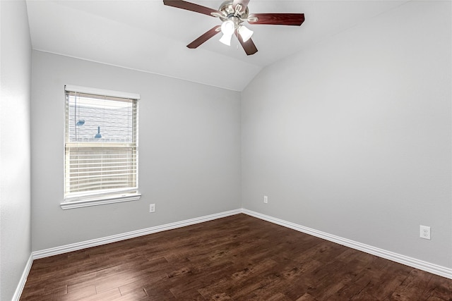 spare room with lofted ceiling, dark wood-style floors, baseboards, and a ceiling fan