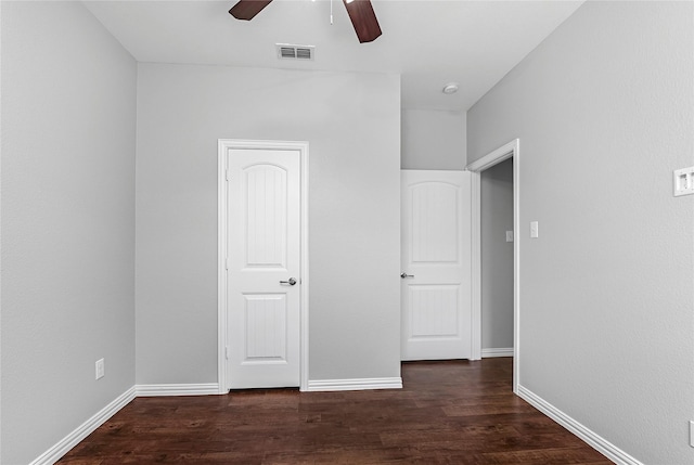 unfurnished bedroom with wood finished floors, visible vents, and baseboards