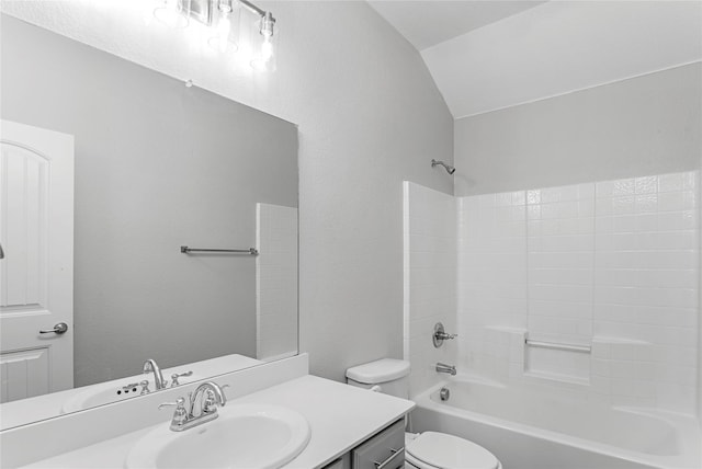 bathroom with toilet, washtub / shower combination, vaulted ceiling, and vanity