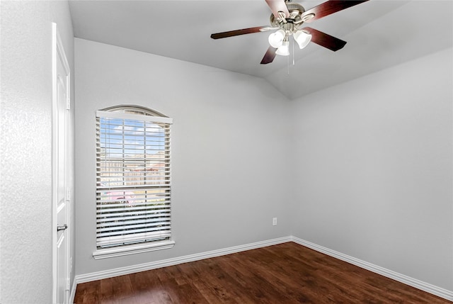 empty room featuring ceiling fan, baseboards, vaulted ceiling, and wood finished floors