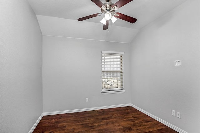 spare room with a ceiling fan, lofted ceiling, dark wood finished floors, and baseboards