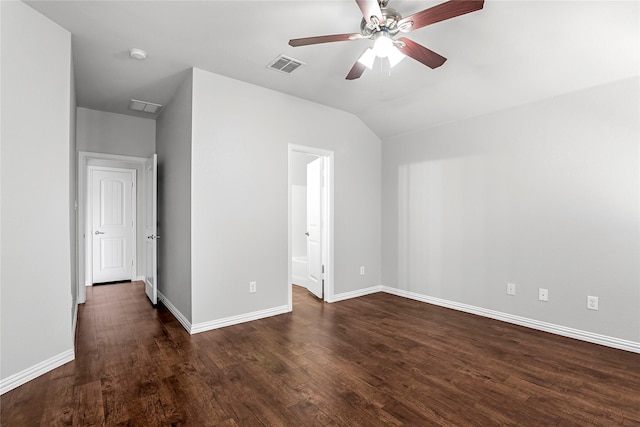 unfurnished bedroom with lofted ceiling, dark wood-type flooring, visible vents, and baseboards