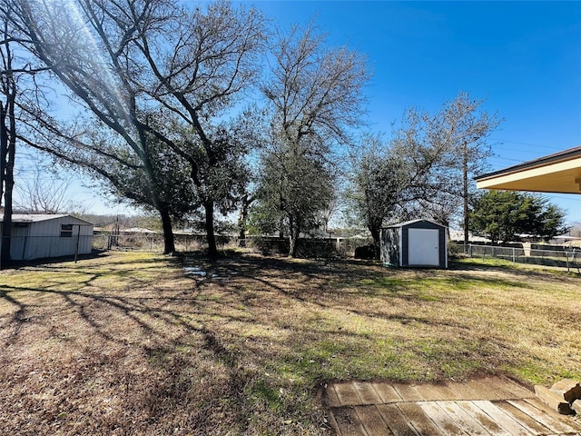 view of yard featuring an outbuilding, a fenced backyard, and a storage unit