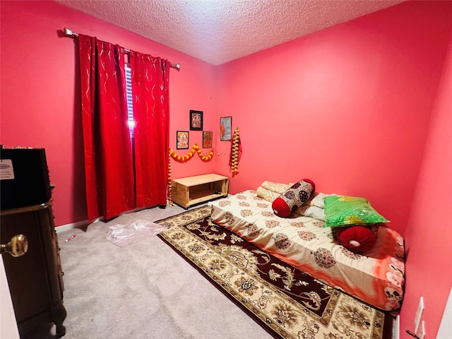 carpeted bedroom featuring a textured ceiling