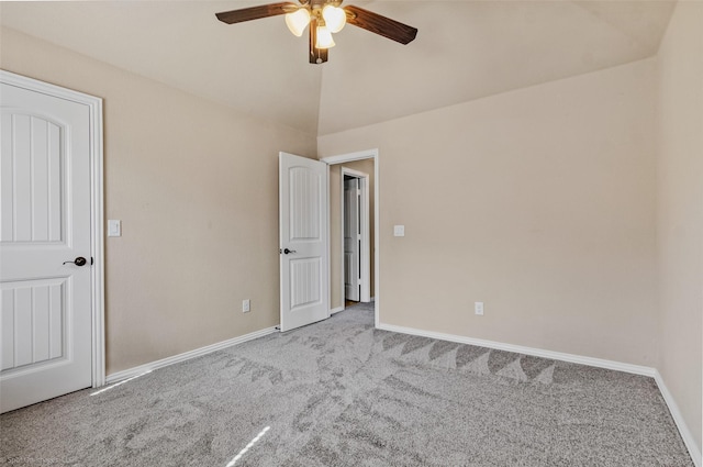 unfurnished bedroom featuring carpet floors, vaulted ceiling, baseboards, and ceiling fan