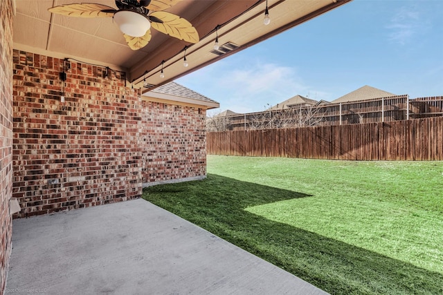 view of yard featuring a patio area, fence, and a ceiling fan