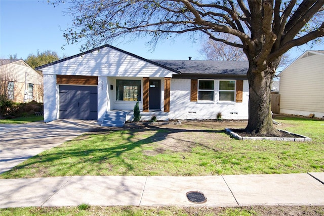 view of front of house with a garage, brick siding, crawl space, and a front yard