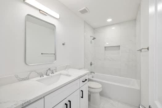 bathroom with visible vents, toilet,  shower combination, vanity, and recessed lighting