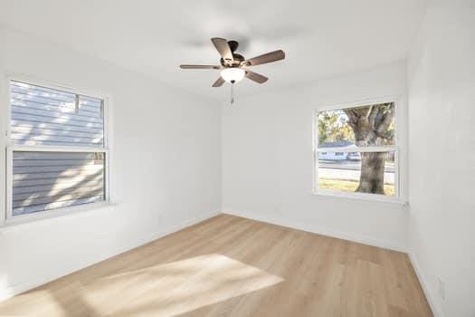 unfurnished room with ceiling fan and wood finished floors