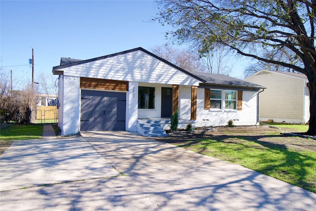 view of front facade featuring a garage, driveway, a front yard, and brick siding