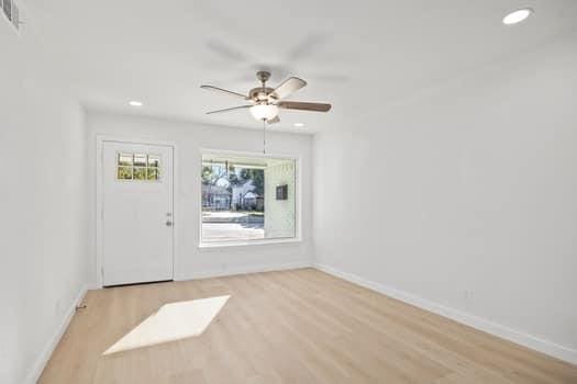 interior space featuring visible vents, baseboards, a ceiling fan, wood finished floors, and recessed lighting