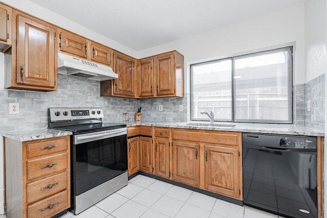 kitchen featuring black dishwasher, light stone countertops, stainless steel electric stove, under cabinet range hood, and a sink