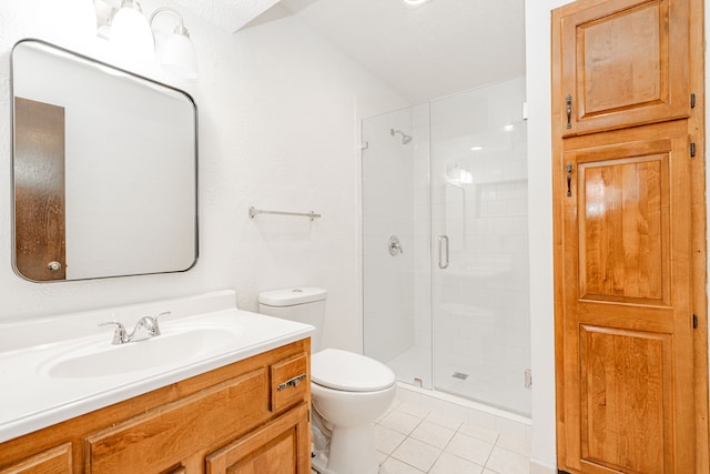 bathroom featuring toilet, a shower stall, vanity, and tile patterned floors