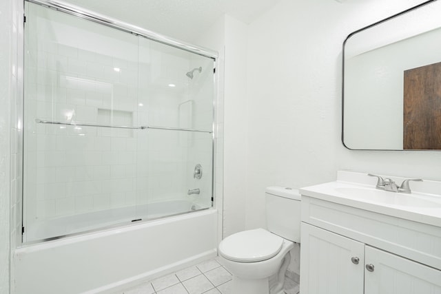 bathroom featuring combined bath / shower with glass door, tile patterned flooring, vanity, and toilet