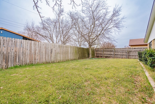 view of yard with a fenced backyard