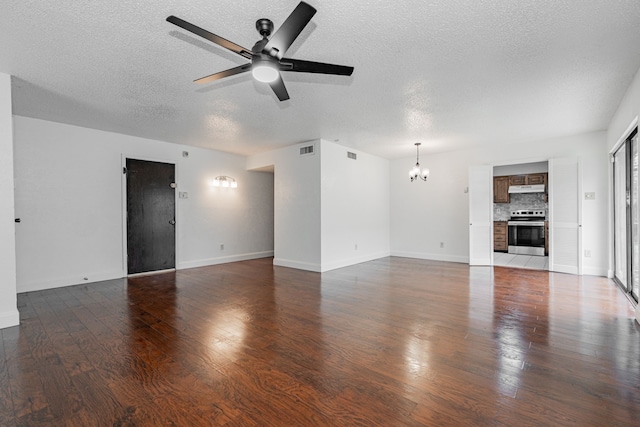 unfurnished living room featuring baseboards, visible vents, hardwood / wood-style floors, and ceiling fan with notable chandelier