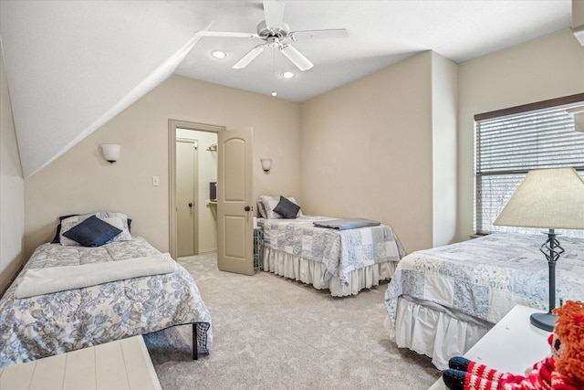 carpeted bedroom with vaulted ceiling and ceiling fan