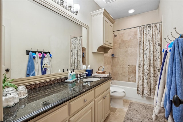 full bathroom with toilet, visible vents, vanity, tile patterned floors, and shower / bath combo with shower curtain