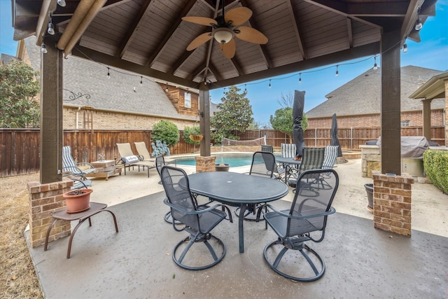 view of patio / terrace featuring ceiling fan, a fenced backyard, a gazebo, a fenced in pool, and outdoor dining space