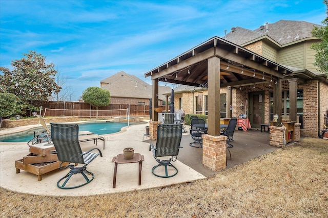 view of swimming pool featuring a fenced in pool, a patio area, a fenced backyard, and a gazebo