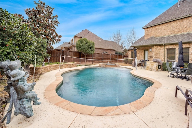 view of pool featuring a pool with connected hot tub, a fenced backyard, a patio, and area for grilling