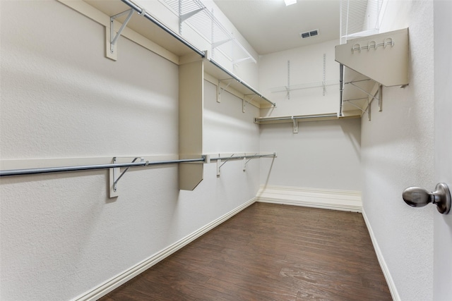 walk in closet with visible vents and wood finished floors