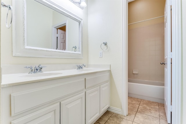 bathroom featuring double vanity, a sink, shower / tub combination, and tile patterned floors