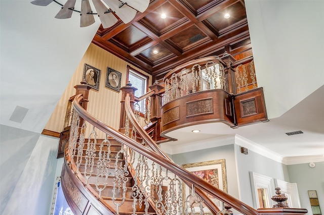 stairs featuring ornamental molding, coffered ceiling, beam ceiling, and visible vents