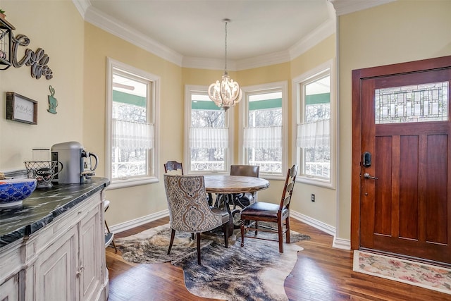 dining area featuring a chandelier, baseboards, dark wood finished floors, and crown molding