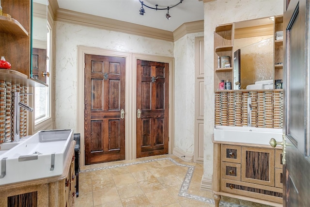 bathroom with crown molding and vanity