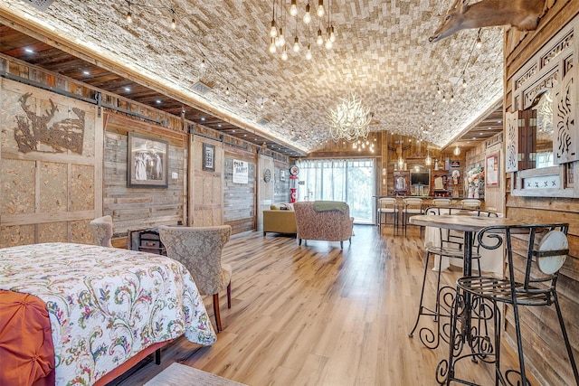 bedroom with brick ceiling, vaulted ceiling, a notable chandelier, and wood finished floors