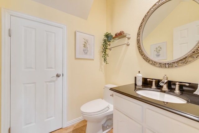 half bathroom with toilet and vanity