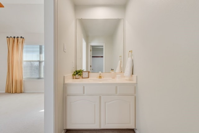 bathroom with vanity and baseboards